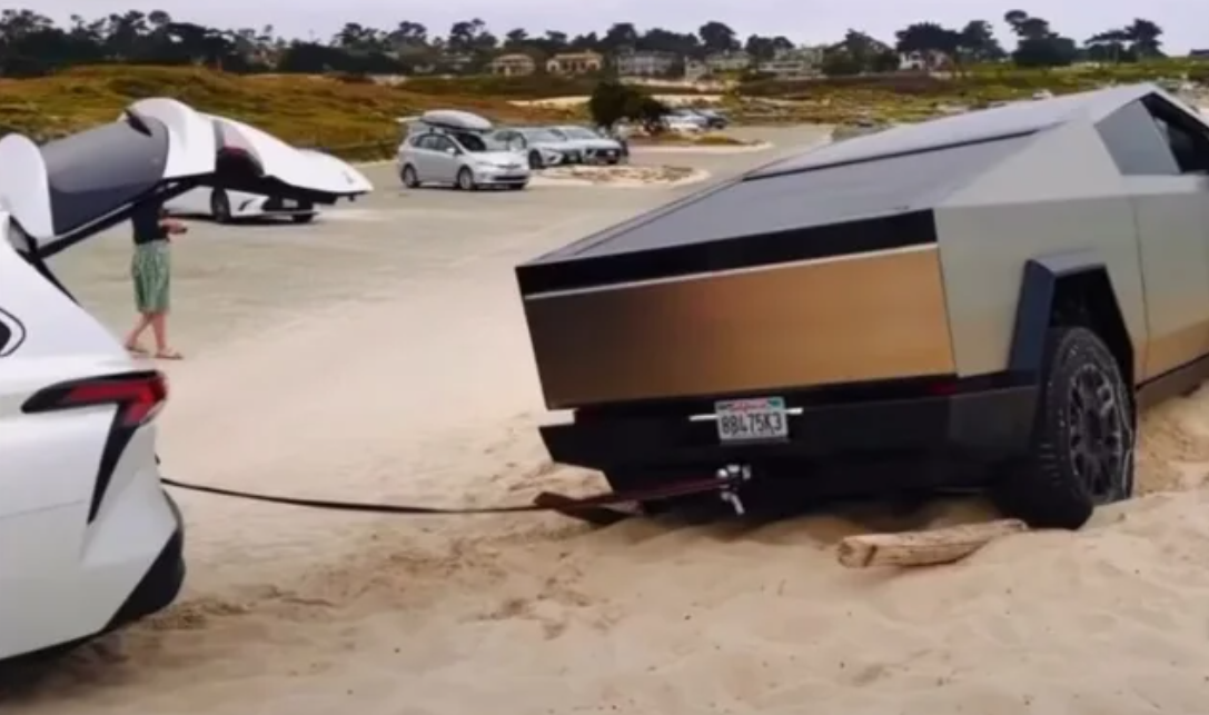 cybertruck getting pulled out of the sand