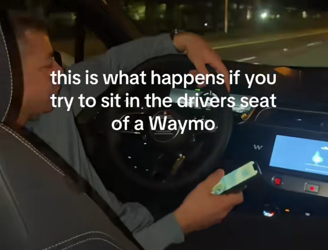 man gets in front seat of waymo
