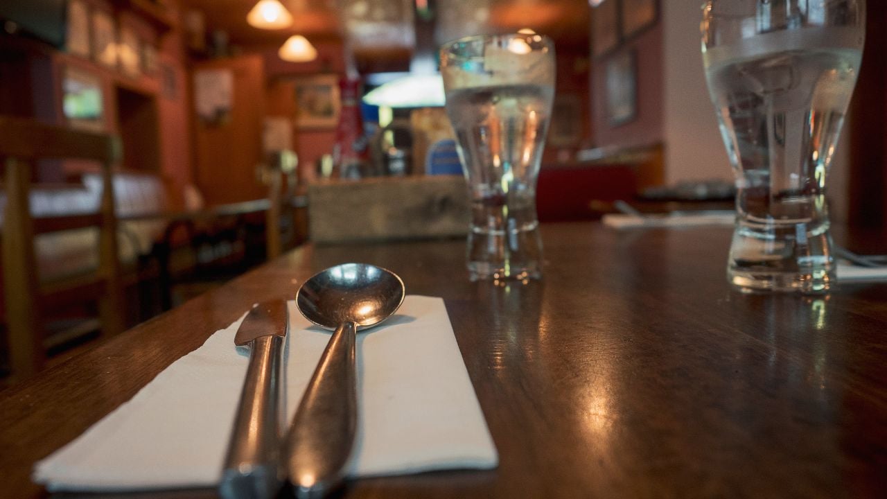 Restaurant table with cutlery and glasses of water