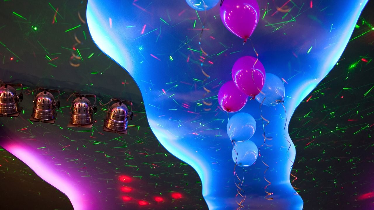 Ceiling lighting colorful spotlights with decorated balloons, celebration background