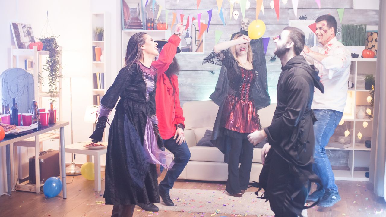 People in Halloween costumes dancing at a celebration