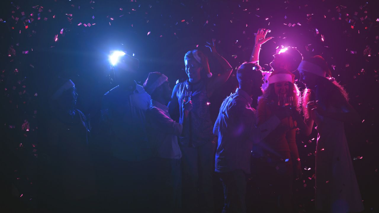 People dancing at a party with confetti