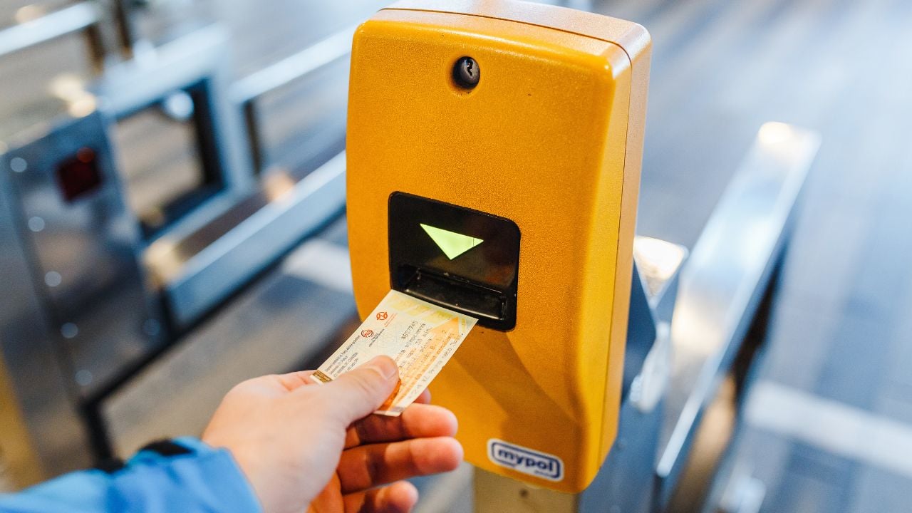 Passenger validating a Prague public transport ticket at a machine