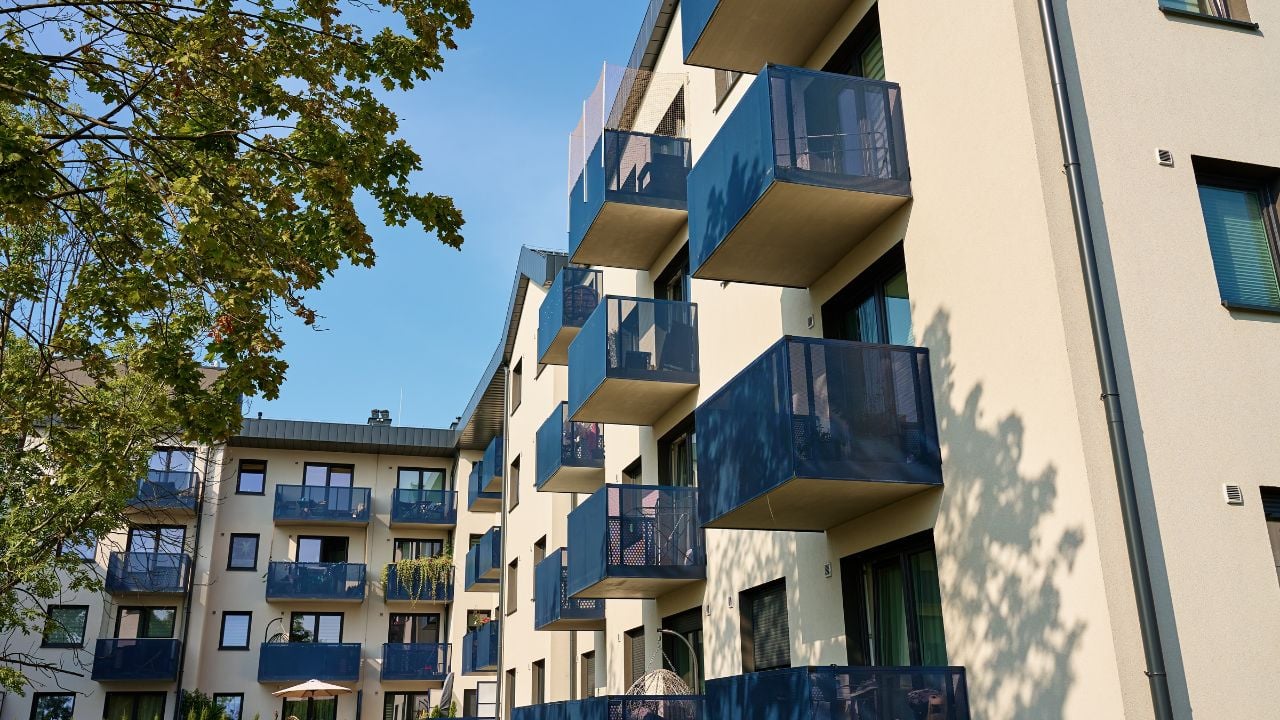 Modern apartment building with balconies and trees