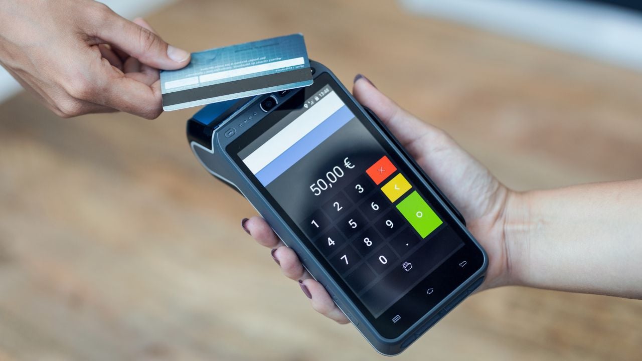 Customer paying by credit card at a shop terminal