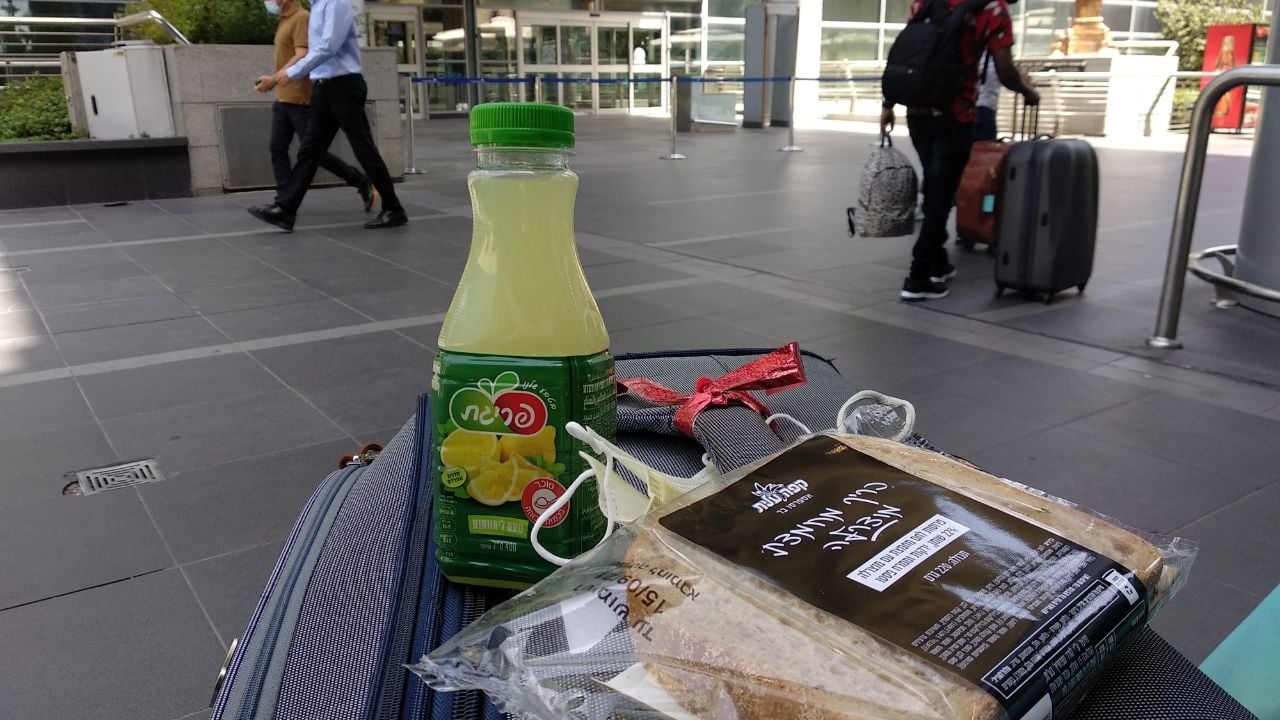 Luggage with juice and breakfast items at an airport