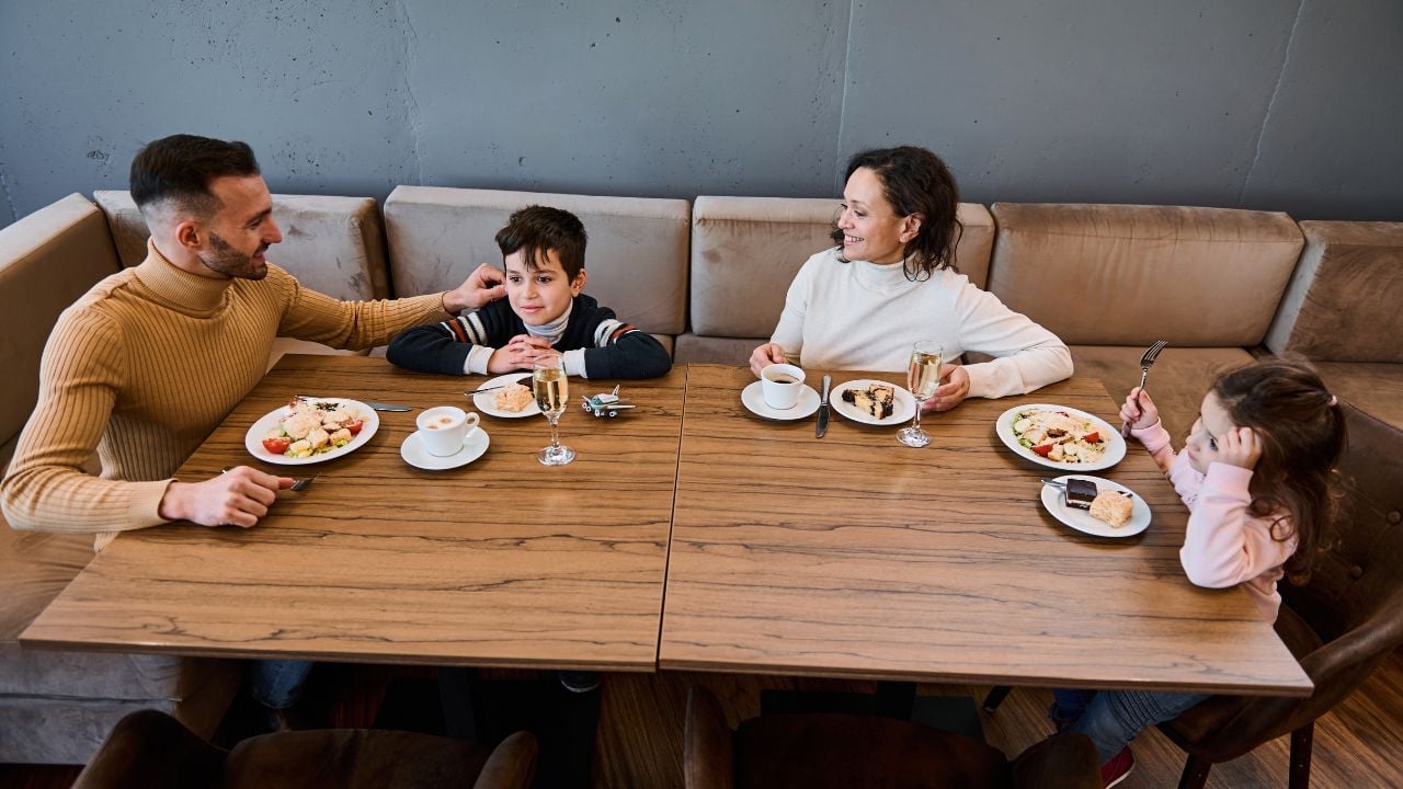Family eating lunch together in an airport departure terminal