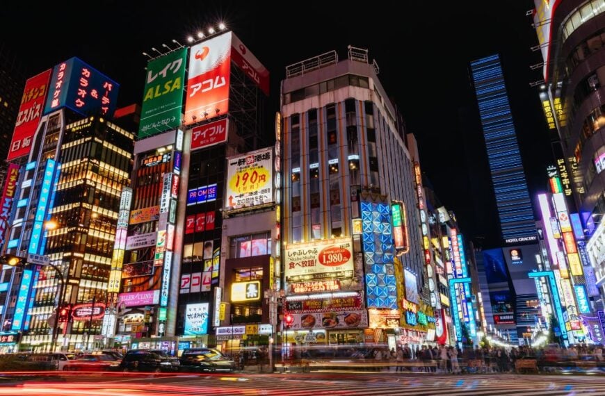 Shinjuku, Japan, May 18 2019: Neon signs illuminate Tokyo’s busy Shinjuku neighborhood at night along Yasukuni-dori Ave with crowds of people