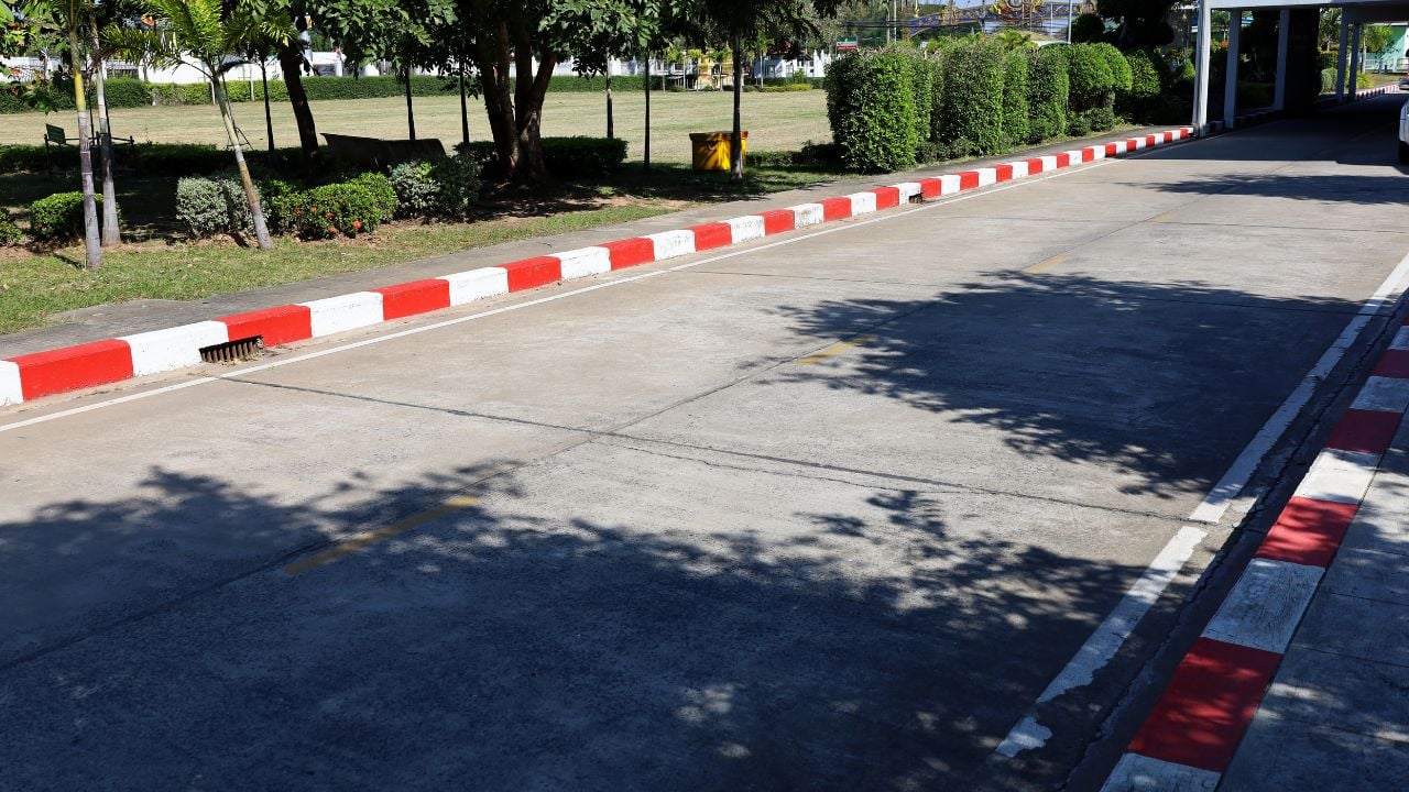 Red and white road markings near a pedestrian crossing