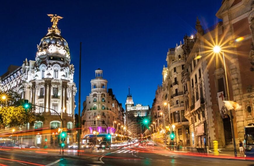 Rays of traffic lights on Gran via street, main shopping street in Madrid at night. Spain, Europe.