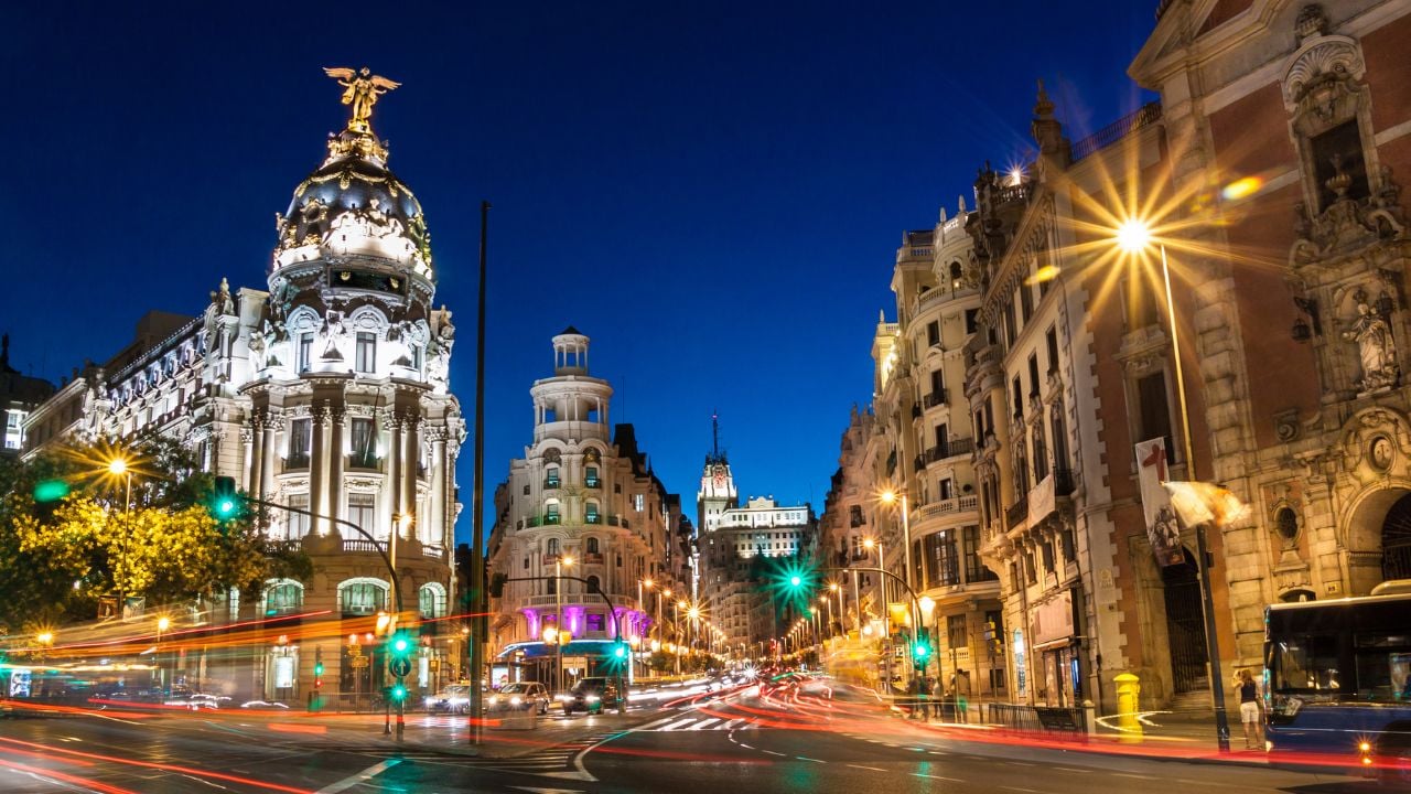 Rays of traffic lights on Gran via street, main shopping street in Madrid at night. Spain, Europe.
