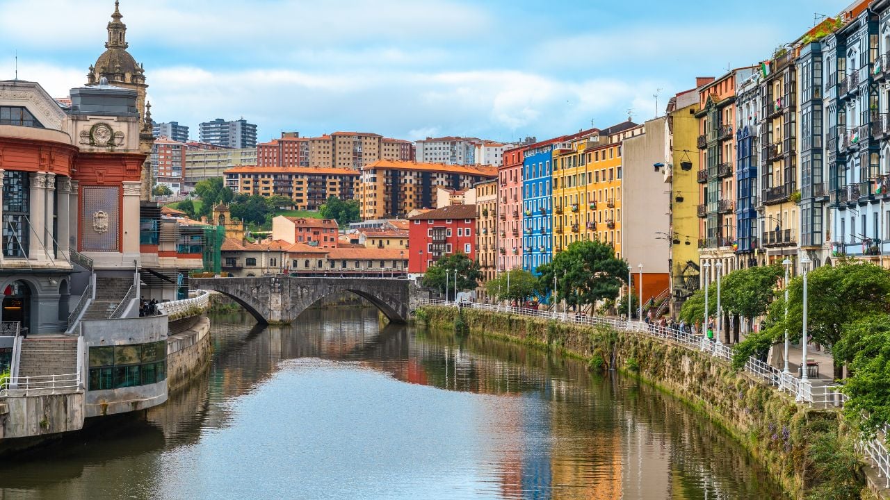 Bilbao waterfront with Ribera Market, the Nervión River, and a bridge