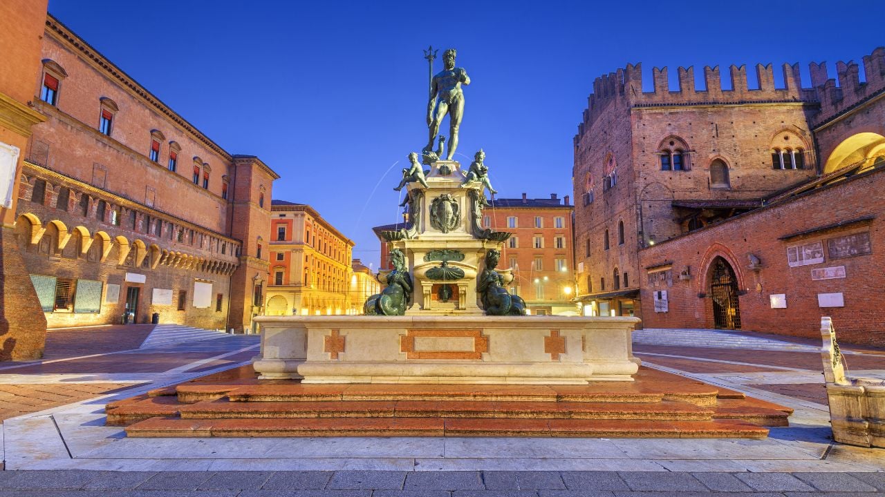 The Fountain of Neptune in Bologna, Italy, at twilight.