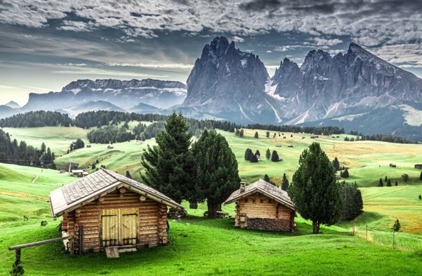 Small wooden huts at sunrise in Alpe di Siusi, Dolomites