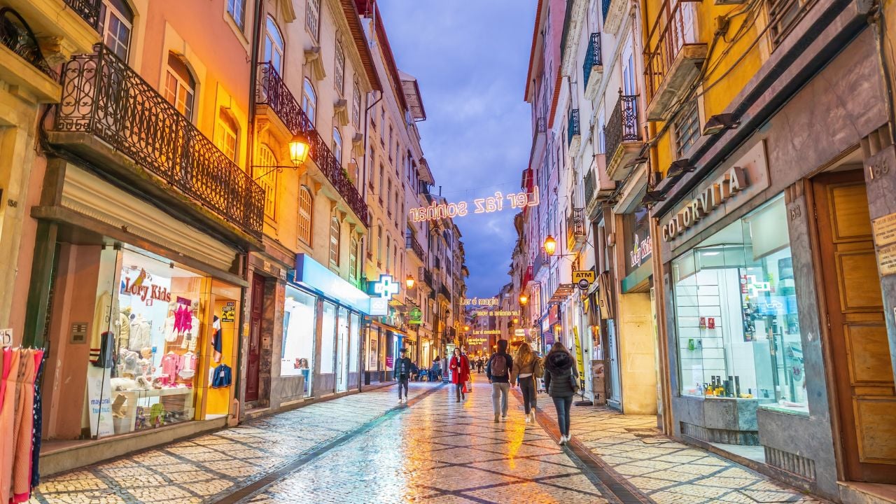 Coimbra, Portugal - January 20, 2023 : Rua Ferreira Borges, a main shopping street in old town Coimbra at night