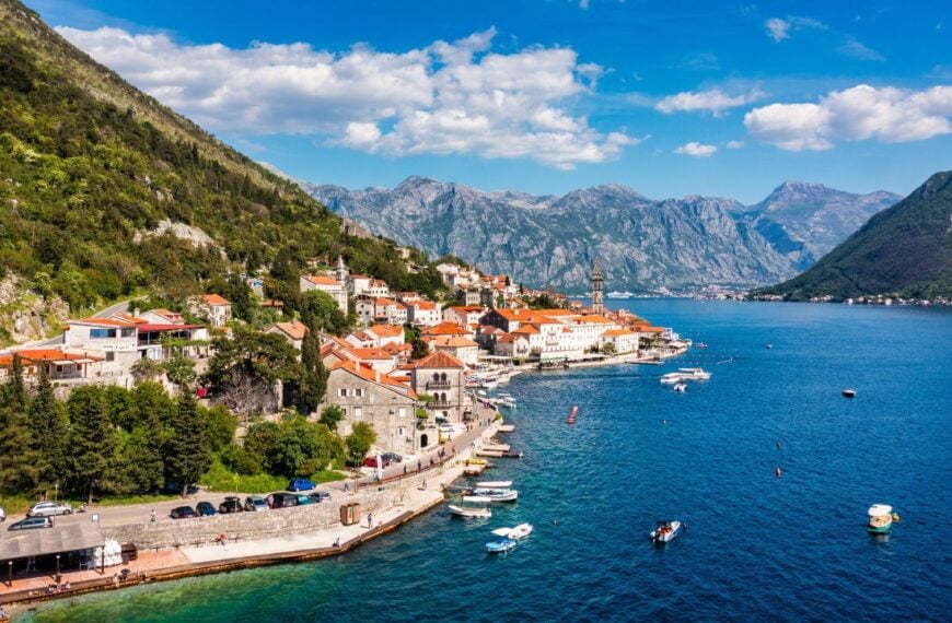 View of the historic town of Perast at famous Bay of Kotor on a beautiful sunny day with blue sky and clouds in summer, Montenegro. Historic city of Perast at Bay of Kotor in summer, Montenegro.