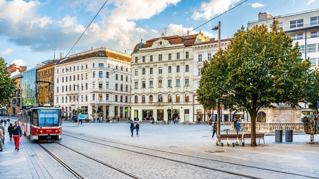 Tram and pedestrians crossing Freedom Square in Brno, Czechia