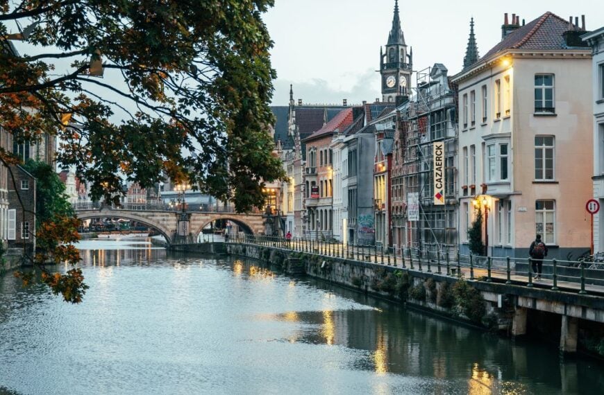 Ghent, Belgium - October 5, 2025 - Charming scene of Ghents canal framed by old houses and soft water reflections.