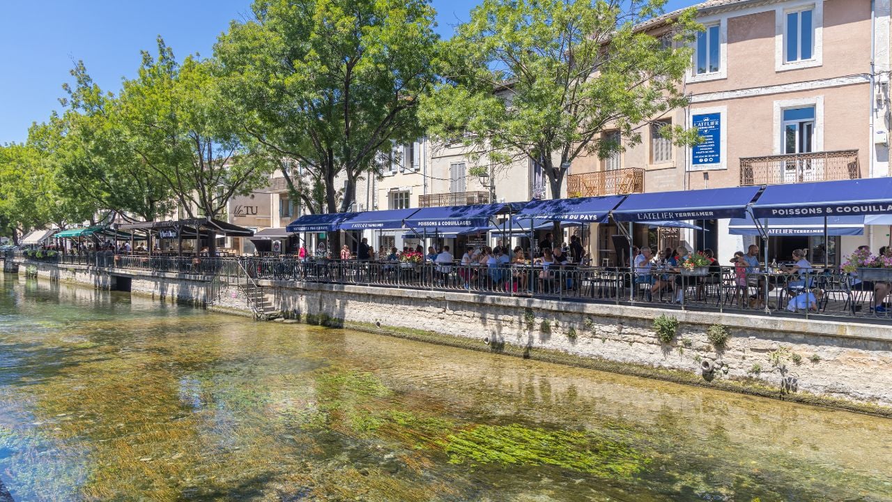 Cafés along a canal in L'Isle-sur-la-Sorgue, Provence, France