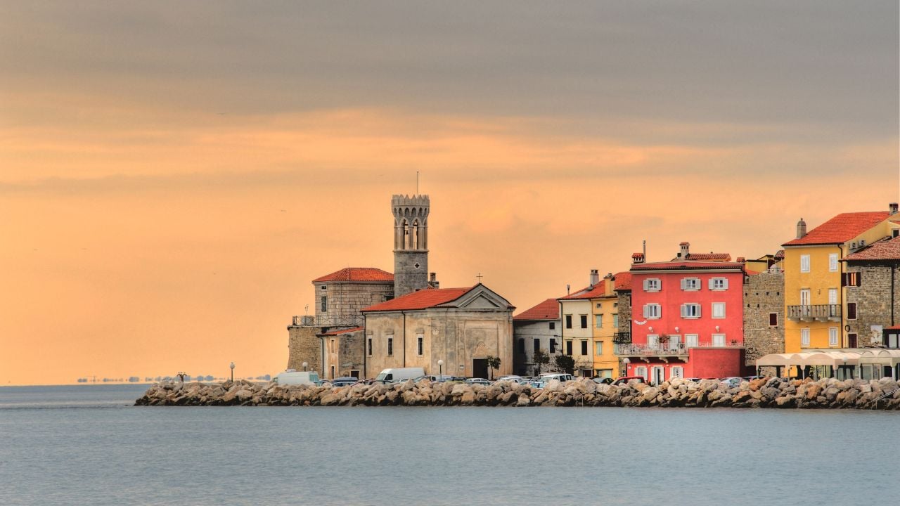 ancient coastal city Piran slovenia central europe - old punta church on a cape at dusk