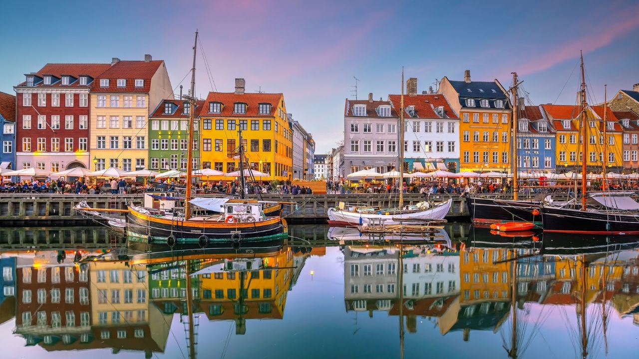 Cityscape of downtown Copenhagen city skyline in Denmark at famous old Nyhavn port at sunset