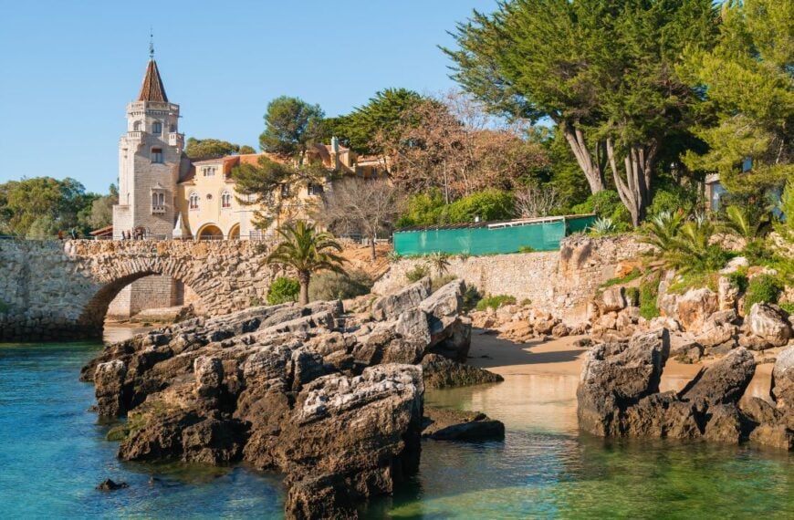 Beautiful beach with rocks in Cascais, Portugal. Old architecture on the coast of Atlantic ocean. Famous travel destination