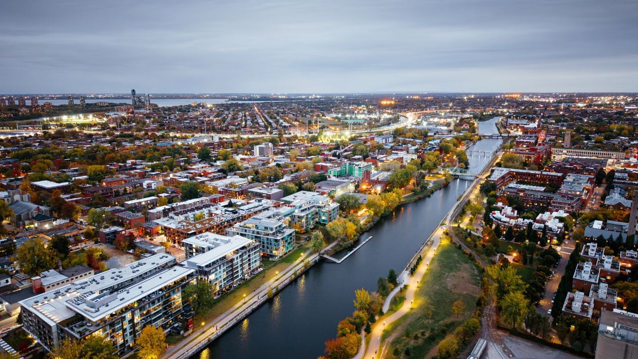 Aerial night view of Montreal with the Lachine Canal and illuminated bridges