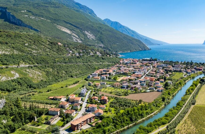 Aerial view of Lake Garda with mountains and coastal valley. Open water, slopes and natural landscape in northern Italy