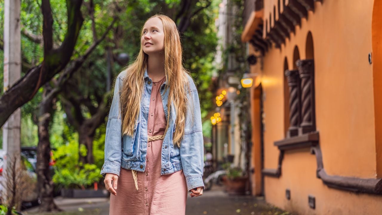 Woman tourist exploring lush streets of Condesa, Mexico City. Family adventure in a vibrant urban oasis. Travel, family bonding, and urban greenery concept in Latin America