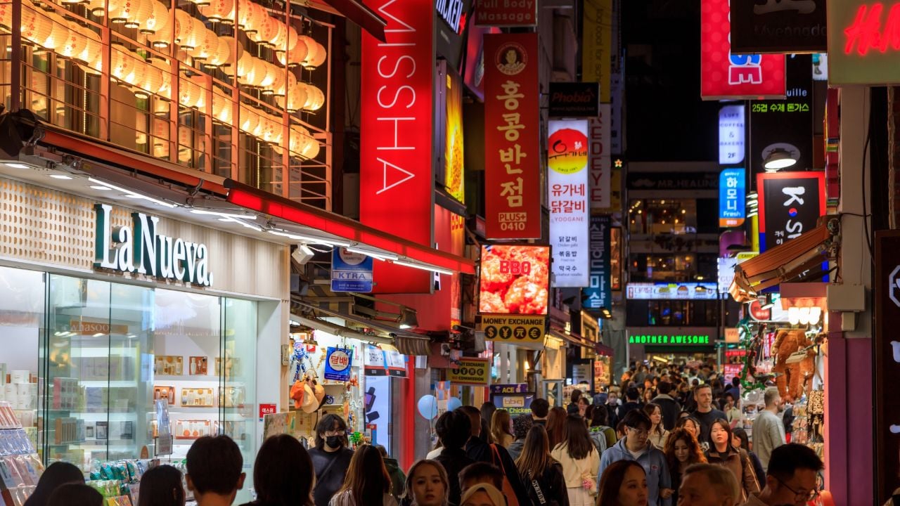 Seoul, South Korea - October 28, 2024: Street scene of the bustling and vibrant shopping district Myeong-Dong at night with illuminated signs, located in Seoul, South Korea.