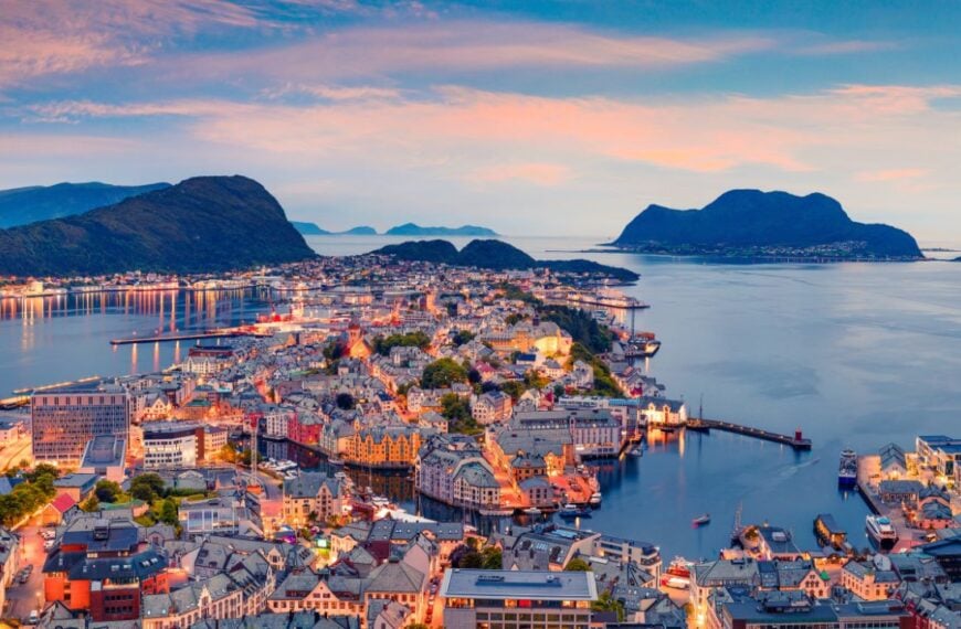 From the bird's eye view of Alesund port town on the west coast of Norway, at the entrance to the Geirangerfjord. Colorful sunset in the North. Traveling concept background.
