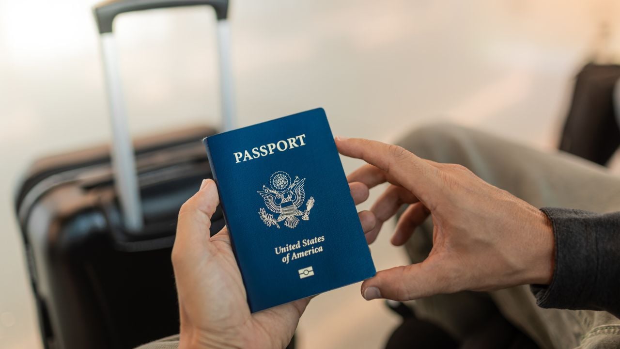 Travelers with USA passport in hand at airport.
