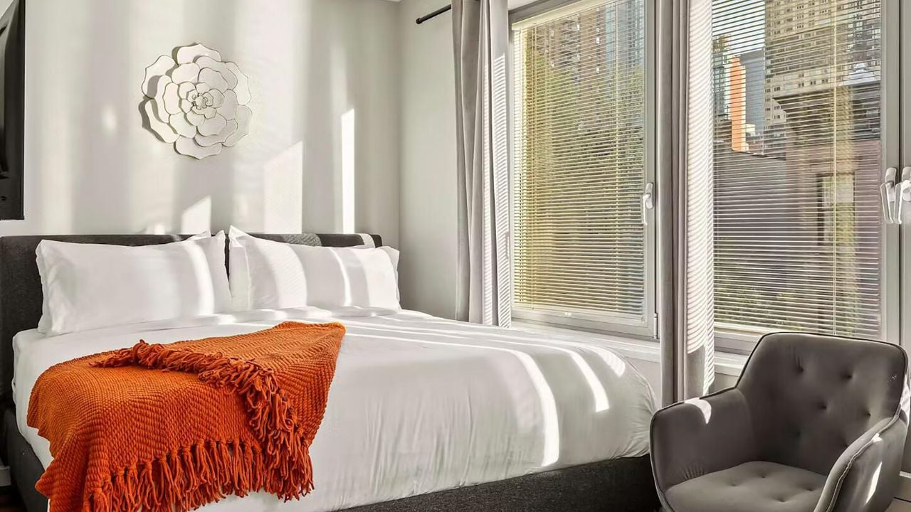 Modern compact hotel bedroom in Scandinavian style.
