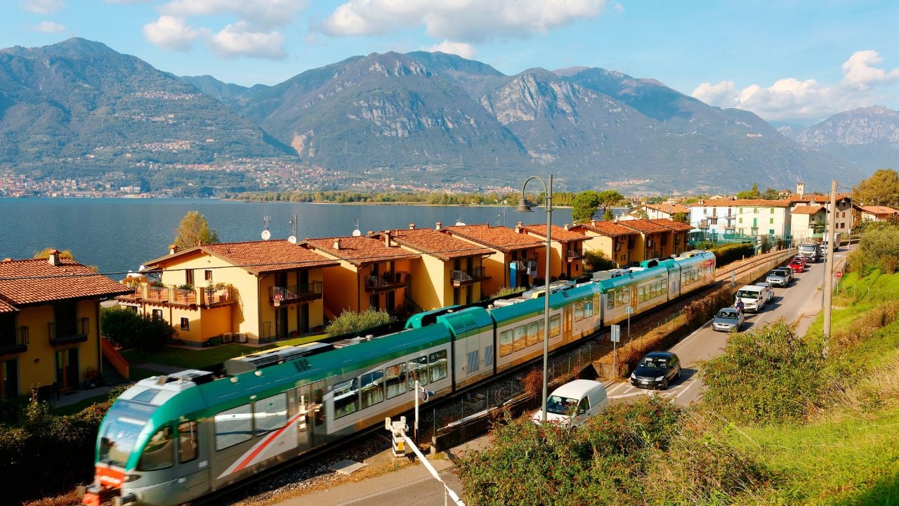 Regional train passing Lake Iseo in Lombardy, northern Italy.