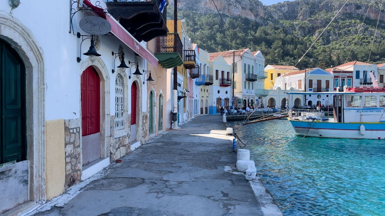 Greece, kastellorizo 8 march 2025. Colorful Waterfront Houses And Cafes In Kastellorizo, Greece, Springtime, Tourism Concept, Travel Destination, Coastal Lifestyle, Real Estate, Vacation Business