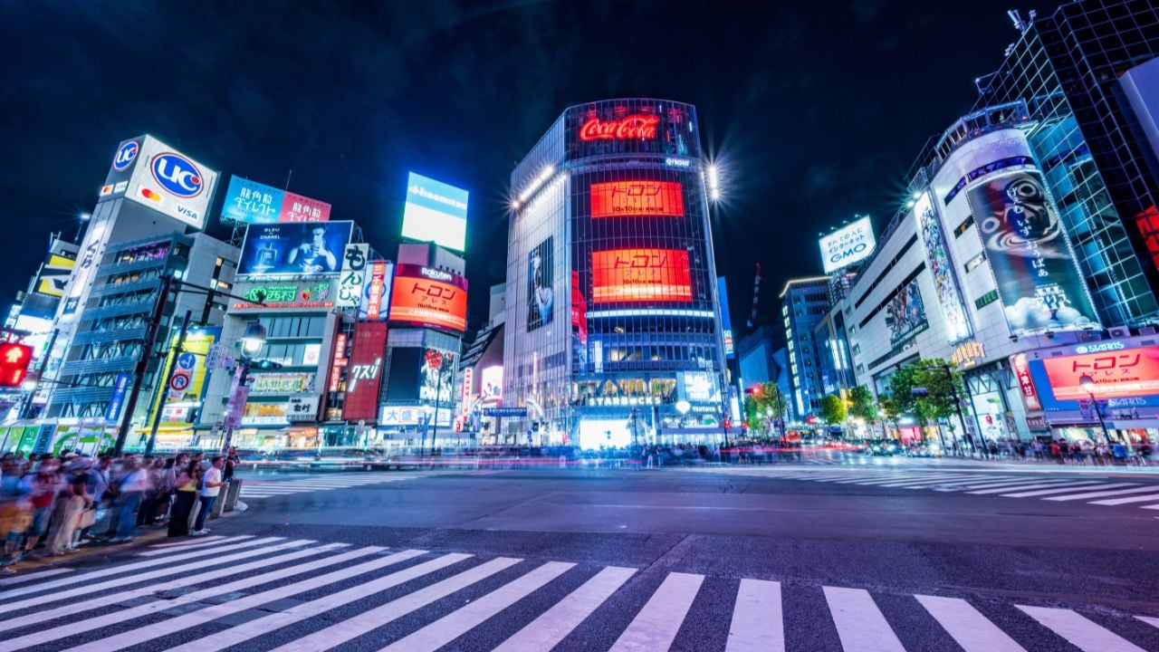Shibuya Scramble Crossing with bright signs in Tokyo, Japan.