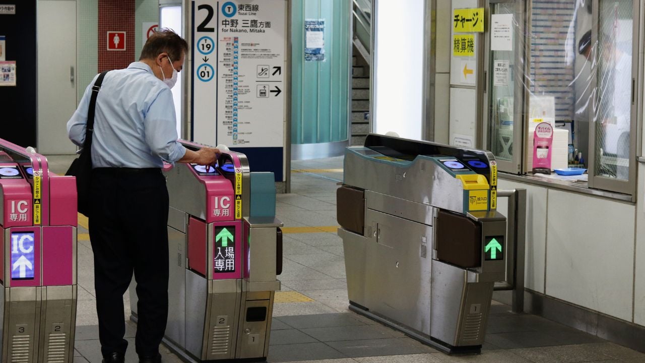 Passenger using an IC card at a ticket gate in Japan.