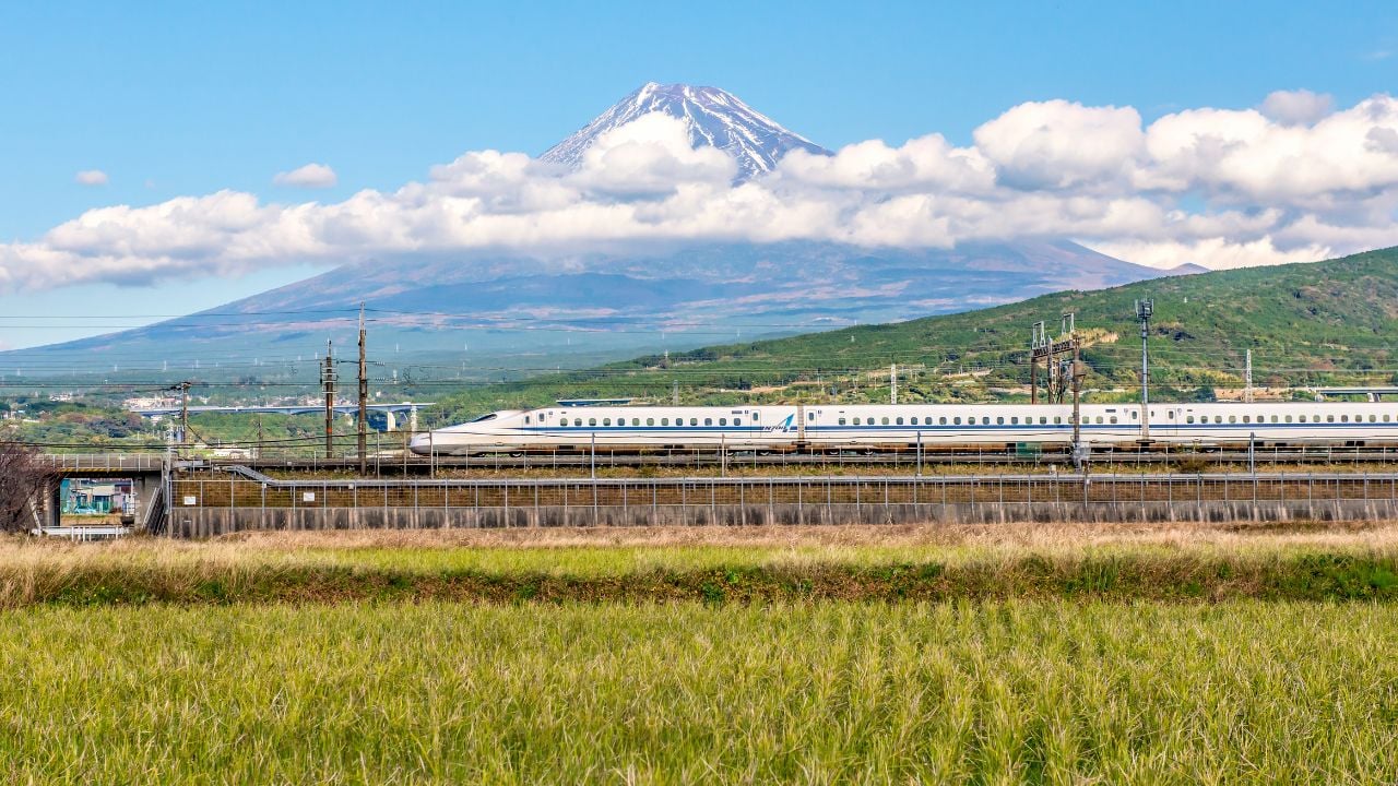 Shinkansen bullet train passing Mount Fuji in Japan.
