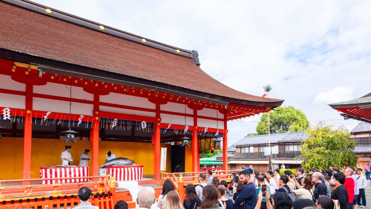 Visitors watching a traditional ceremony at a shrine in Kyoto, Japan.