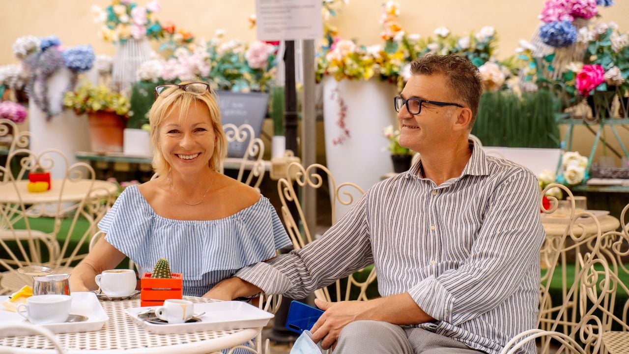 Couple sitting at an outdoor café in a European town.