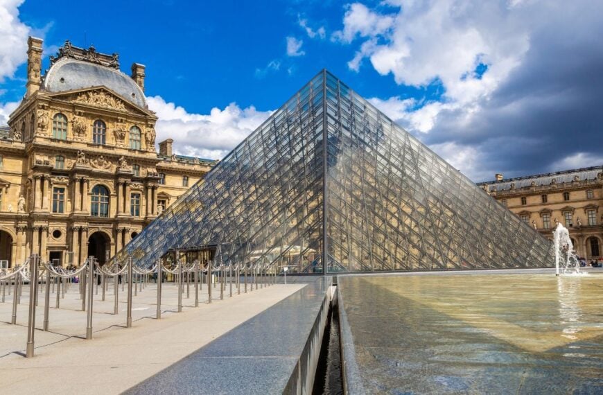 PARIS, FRANCE - JUNE 01, 2022: The Louvre and Pyramid - is one of the world's largest museums in Paris in a summer day, France