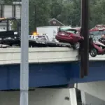 car dangling off bridge after crash