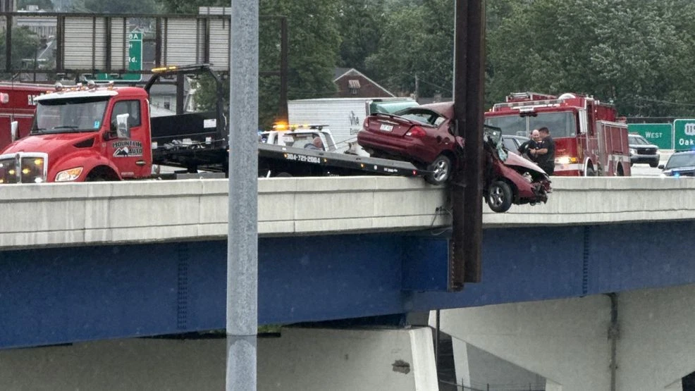 car dangling off bridge after crash