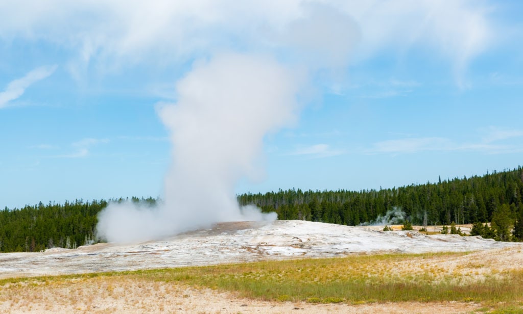 old faithful erupting in yellowstone national park