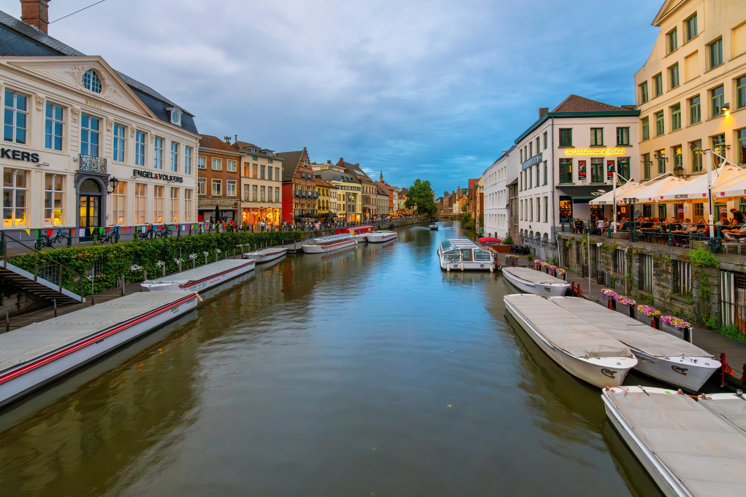 Illuminated waterfront cafés and restaurants along the Leie River in Ghent, Belgium