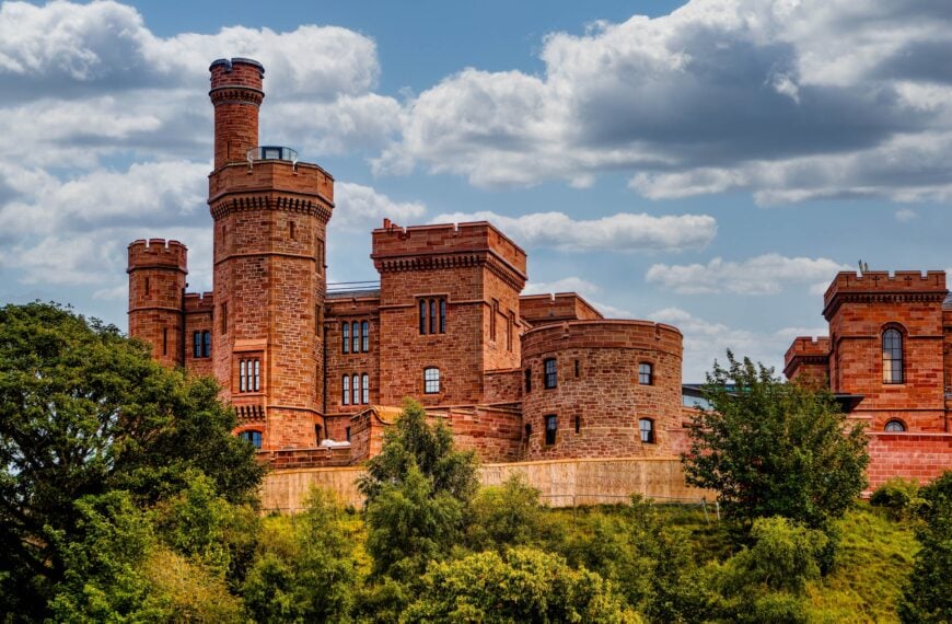 INVERNESS, SCOTLAND - Aug 21, 2025: The red sandstone of Inverness Castle, perched high on a cliff overlooking the River Ness, stands against a bright summer sky in the Highland capital