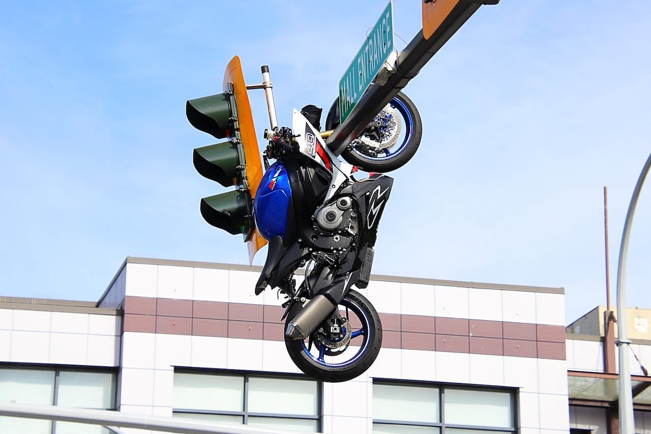 motorcycle ends up on street sign