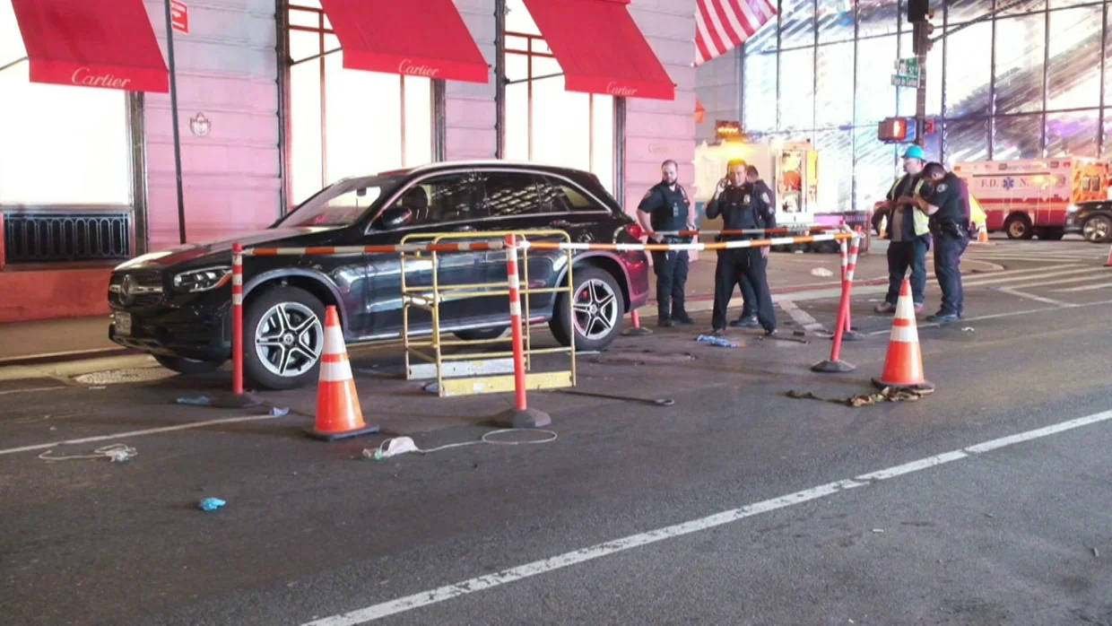 woman steps out of car and falls into manhole