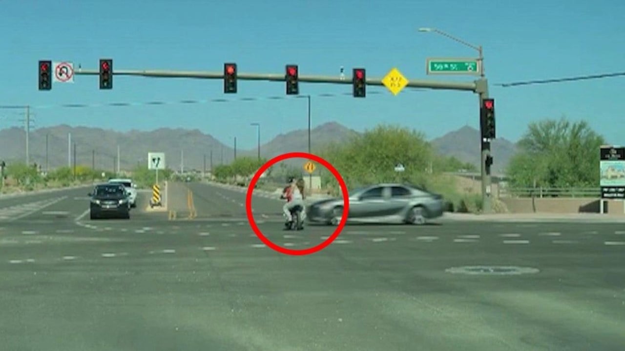 E-bike riders nearly hit by car