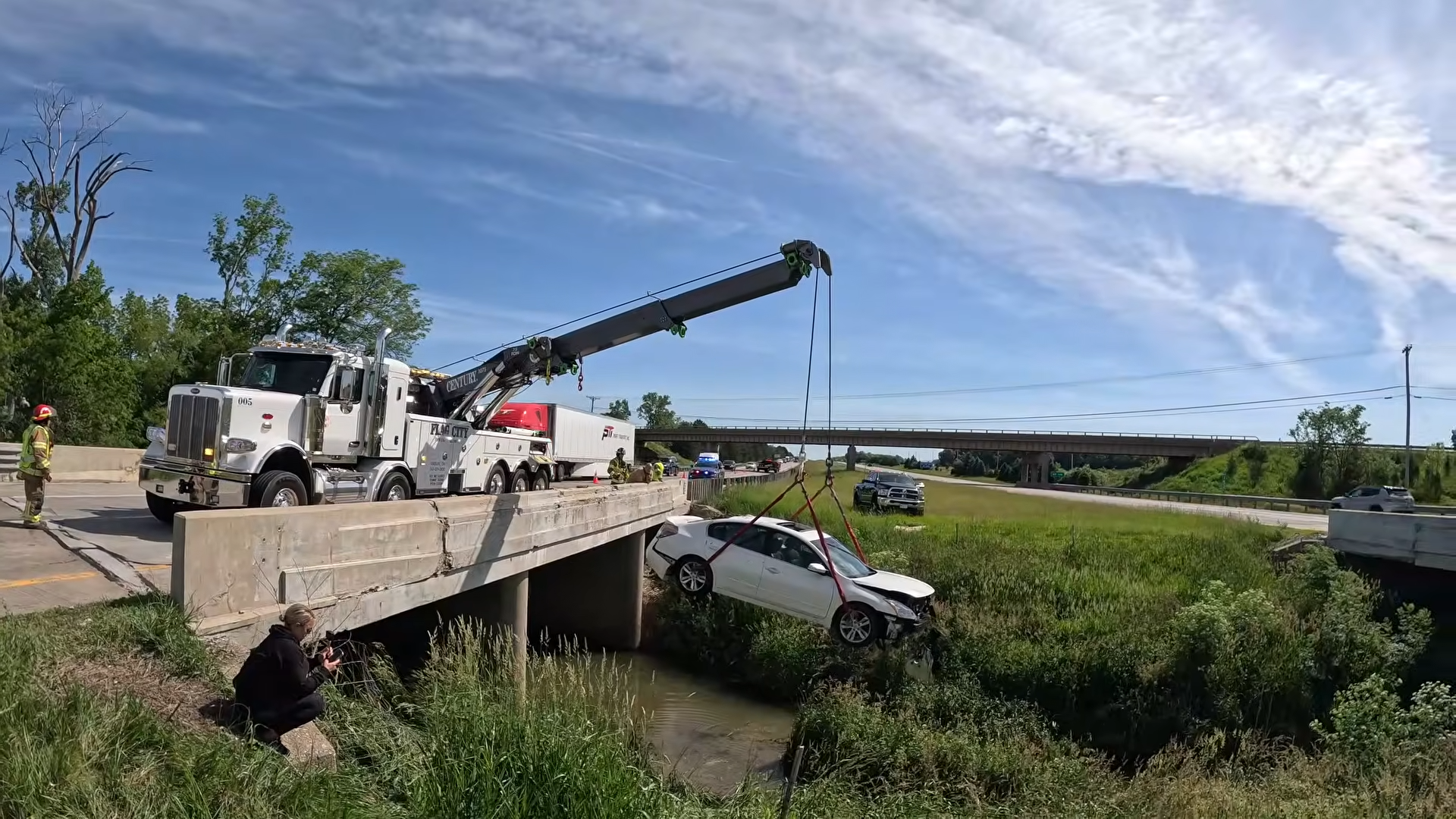 car getting lifted from bridge crash